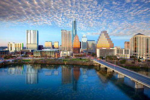 The austin skyline in austin, texas, shines on a late afternoon the iconic austin highrises are reflected in lady bird lake 